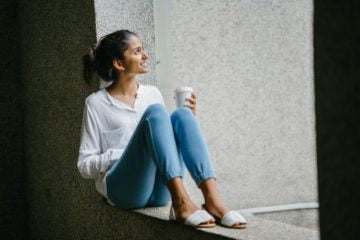 A woman stares out of her window