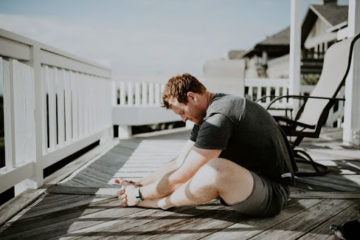 A man doing meditation on a dock